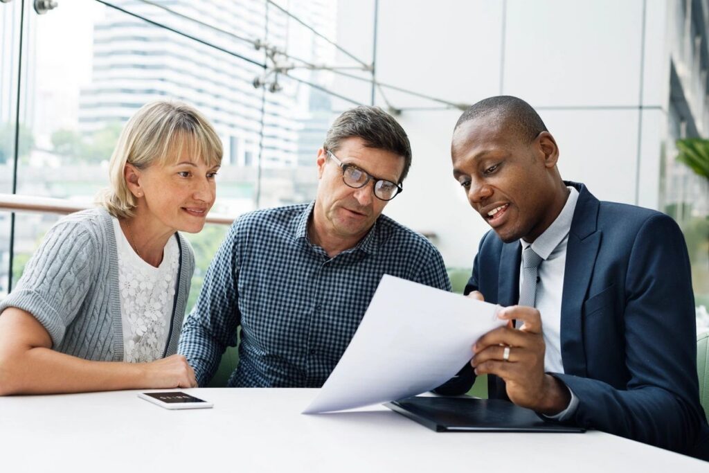 Advisor reviewing insurance documentation with clients