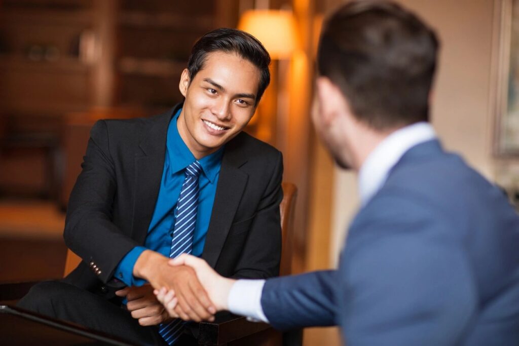 ForeGuard advisor and client shaking hands, representing a partnership to strengthen compliance.